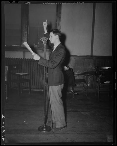 Miscellaneous (1939 Kentuckian) (University of Kentucky); man standing in front of a microphone