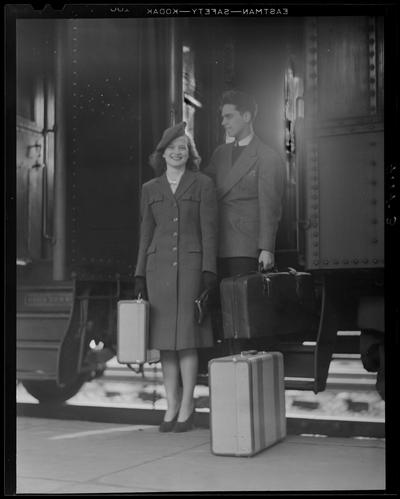 Life; getting off train (1939 Kentuckian) (University of Kentucky); a man and a woman stepping of the train will luggage in hand