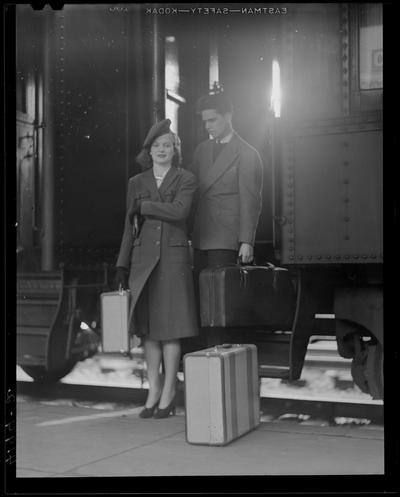 Life; getting off train (1939 Kentuckian) (University of Kentucky); a man and a woman stepping of the train will luggage in hand
