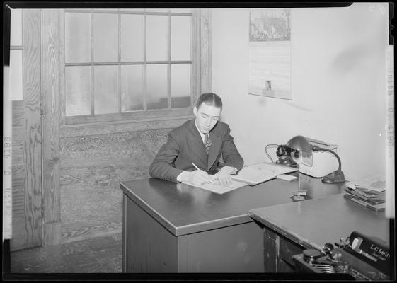 Smith (1939 Kentuckian) (University of Kentucky); man sitting at a desk writing