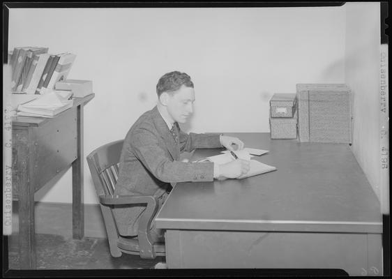Quisenberry (1939 Kentuckian) (University of Kentucky); man sitting at a desk writing
