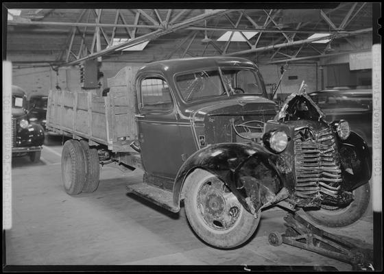 Stoll, Muir, Townsend & Park (attorneys, lawyers; 107 Cheapside); wrecked truck parked in a garage, damaged front end, front view