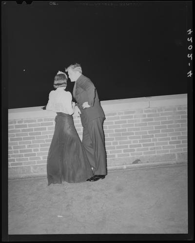 Delta Chi Dance (1939 Kentuckian) (University of Kentucky); man and a woman (couple) standing next to a brick wall