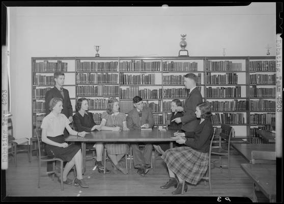 Versailles High School, Debating Team; members sitting around a table in the library