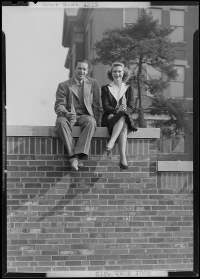 Sour Mash; man and woman sitting on brick wall drinking soda out of bottles