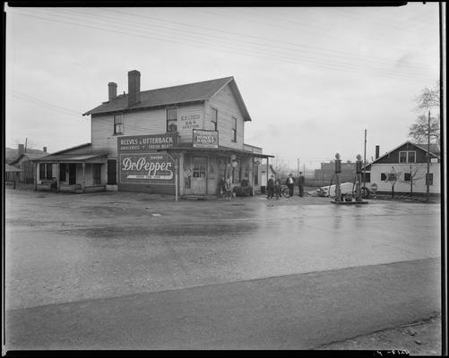 Phoenix Roofing; R.H. Curtis Gas Station (filling station) and Reeves & Utterback Grocers 750 East 3rd (third); exterior of building before construction; two (2) men and a group of children in front of building