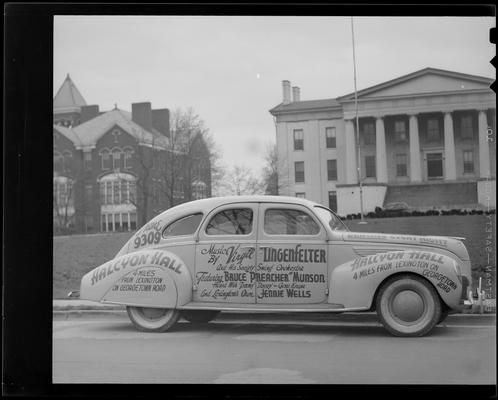 Halcyon Hall; car parked next to curb; advertisements on car read 