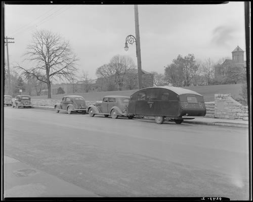 Pershing Rifles, (University of Kentucky); car & trailer parked next to the curb, rear of trailer reads 
