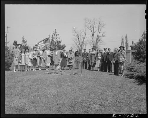 Veterans Hospital; tree planting ceremony, group gathered around a freshly planted tree, American flag and an American Legion Auxiliary flag are being displayed