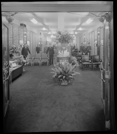 Baynham Shoe Company, 107-109 East Main Street; interior, group of men standing next to chairs