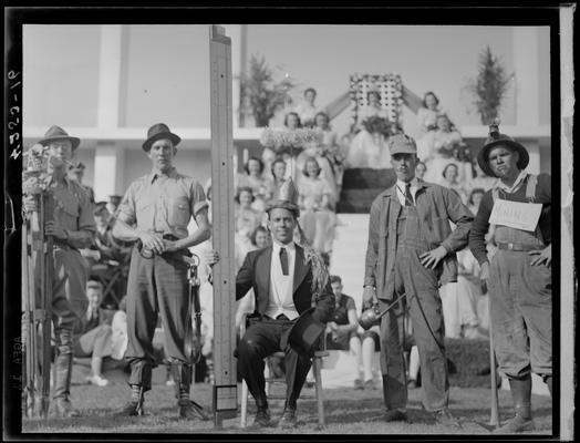 May Day Parade & Festivities (1939 Kentuckian) (University of Kentucky); group of men in costume (dressed as various occupations), May Day Queen and her court can be seen in the background