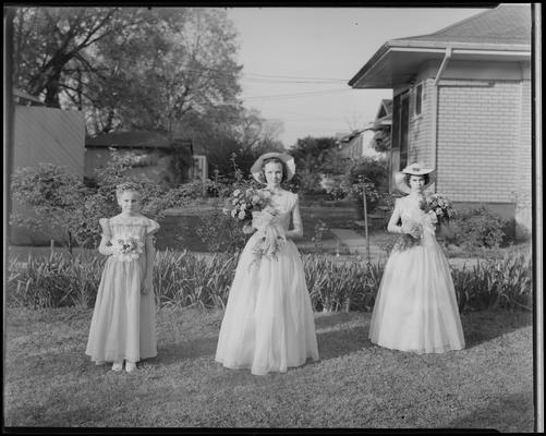 Mrs. Joe Lail; group portrait on lawn, young girl and two women dressed in formal attire holding bouquets