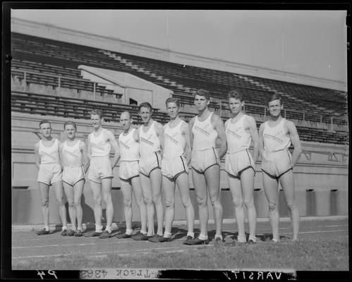 University of Kentucky Varsity and Freshman track team, (1940 Kentuckian) (University of Kentucky); group portrait, four varsity team members standing on track