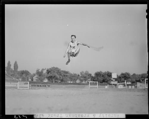 University of Kentucky Varsity and Freshman track team, (1940 Kentuckian) (University of Kentucky); individual member performing the long jump, member in midair