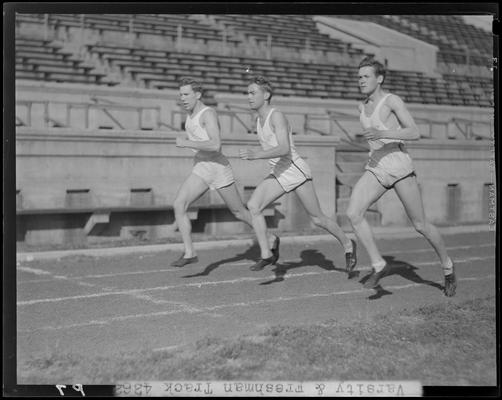 University of Kentucky Varsity and Freshman track team, (1940 Kentuckian) (University of Kentucky); three members running on the track