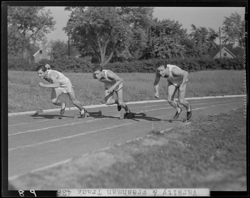 University of Kentucky Varsity and Freshman track team, (1940 Kentuckian) (University of Kentucky); three members sprinting off the starting blocks (