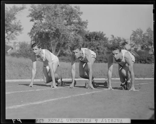 University of Kentucky Varsity and Freshman track team, (1940 Kentuckian) (University of Kentucky); three members in the ready stance at the starting blocks