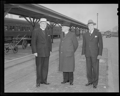 Mayor E. Reed Wilson, Reverend Derwyn Trevor Owen and Dr. John W. Mulder standing next to the train station loading area