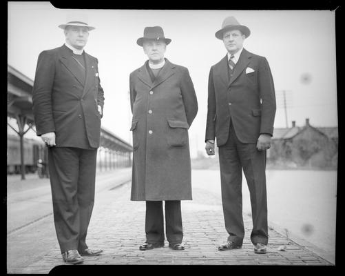 Mayor E. Reed Wilson, Reverend Derwyn Trevor Owen and Dr. John W. Mulder standing next to the train station loading area