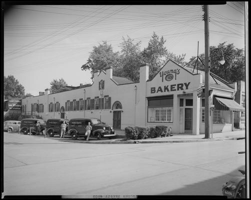 Young's Bakery; (corner of Limestone and Vine); exterior, men standing next to Young's Bakery delivery trucks. A sign for Louis Rosenberg can be seen in the background