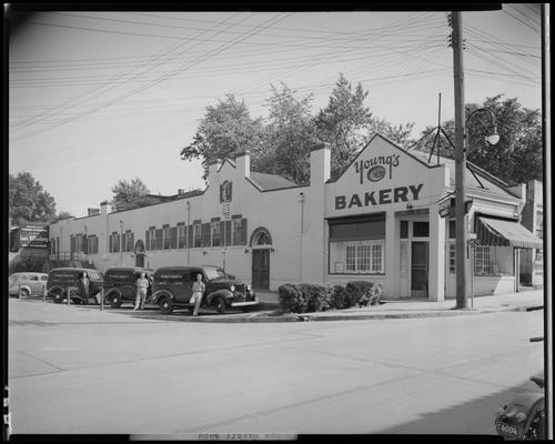 Young's Bakery; (corner of Limestone and Vine); exterior, men standing next to Young's Bakery delivery trucks. A sign for Louis Rosenberg can be seen in the background