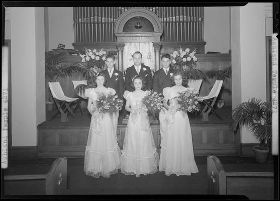 Ashland Avenue Temple; interior, group portrait; three women in formal dress (attire) holding bouquets, three men standing behind the women