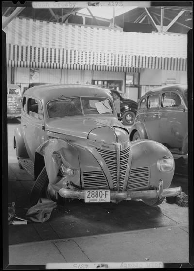 John Crosby; two wrecked cars, Bentley & Baker; damaged (wrecked) car parked in lot, damaged front end and passenger side; 1939 OHIO (OH) license plate 2880F (2880-F)