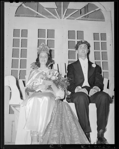 Centre College (Danville); Festival; a man and a woman in formal dress (attire) are sitting next to each other; woman is crowned and is holding a bouquet, the man has a wreath of leaves on his head