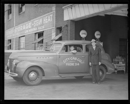 Fred Bryant Motor Car Company, 728 Bullock Avenue; Garland Bryant; City cab company car with driver parked next to service station; man standing next to car