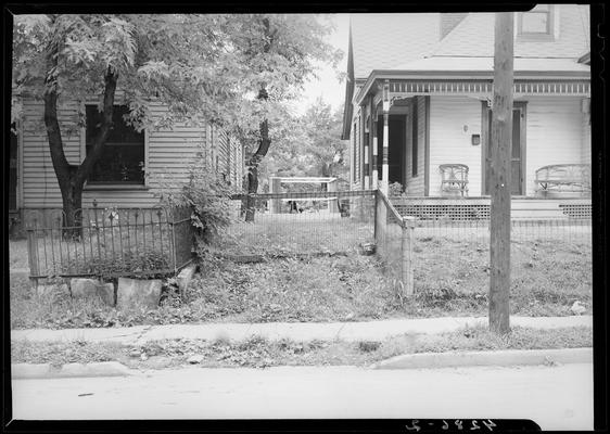 Central Kentucky Natural Gas Company (336 West Main); view of the sidewalk and fence bordering two adjacent houses