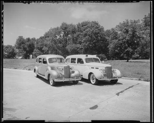 Kerr Brothers Funeral Home, 465 East Main; cars, two cars (hearse and ambulance) parked side by side, front view