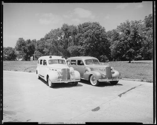 Kerr Brothers Funeral Home, 465 East Main; cars, two cars (hearse and ambulance) parked side by side, front view
