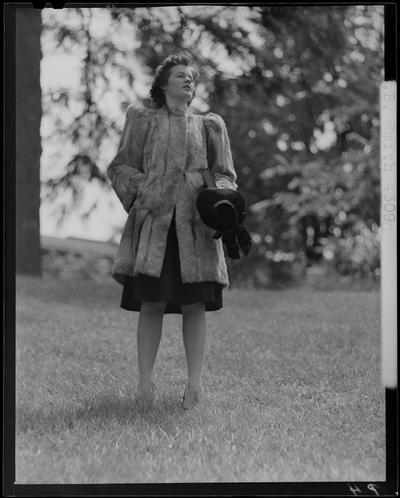 B.B. Smith & Company, 264 West Main; woman in a fur coat standing on the grass (modeling)