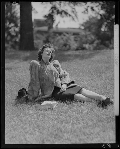 B.B. Smith & Company, 264 West Main; woman in a fur coat sitting on the grass (modeling)