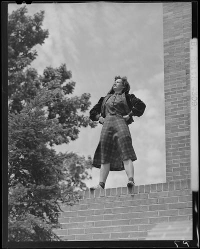 B.B. Smith & Company, 264 West Main; woman in dress standing on a brick wall