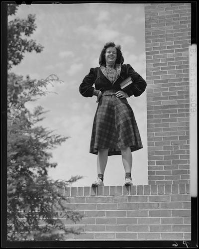 B.B. Smith & Company, 264 West Main; woman in dress standing on a brick wall