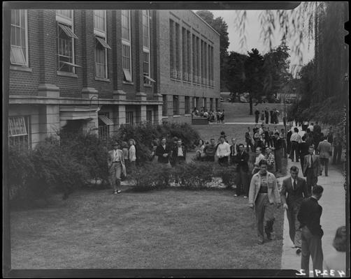 Freshman Registration (Kentuckian 1940) (University of Kentucky); exterior, a group of students waiting in line outside of building for registration