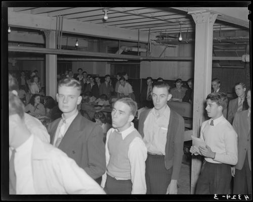 Freshman Registration (Kentuckian 1940) (University of Kentucky); interior, a group of students waiting in line inside of registration office