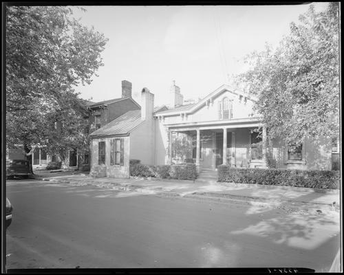 Kennedy House or Sloan & Baxter House; (Second Street?); exterior view of houses, 119 street number seen on the middle house; Lafayette Studios car parked on the street