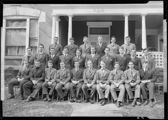 Phi Delta Theta; member group portrait on the porch of the fraternity house