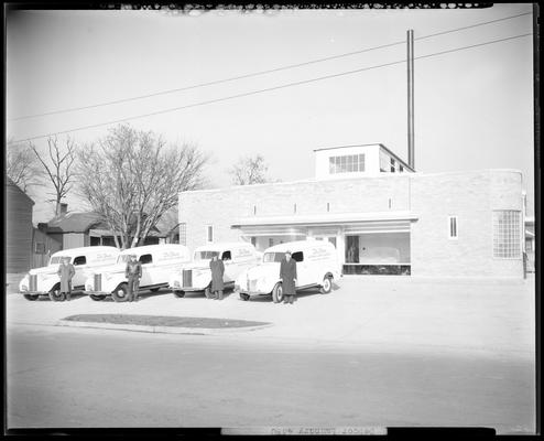 De Boor Laundry and Dry Cleaning, 365 Euclid Avenue: exterior view of business, four delivery trucks parked in front of building, drivers standing next to trucks