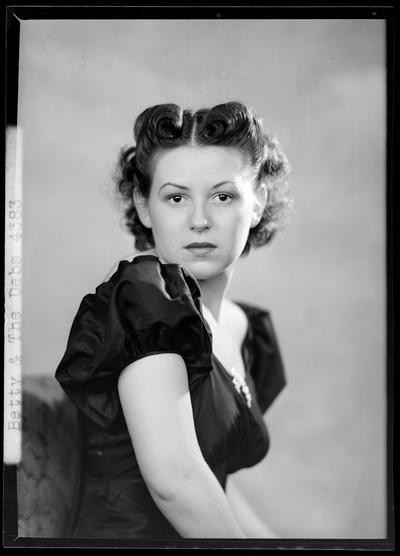 Betty Coed & the Debs; portrait of a woman in a dress, head shot