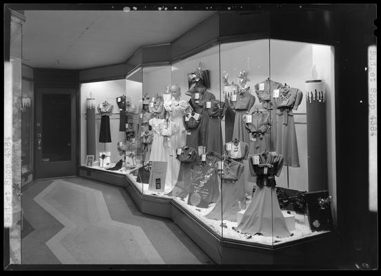 Budget Dress Shop, 206 West Main; window display, photographed at night