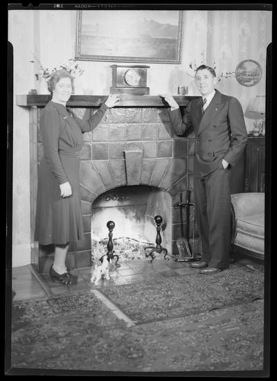 W.B. Griggs; interior of home; man and woman standing next to a fireplace