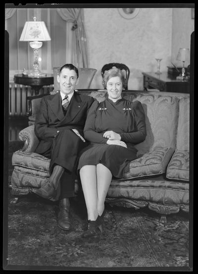 W.B. Griggs; interior of home; man and woman sitting on a sofa (couch, love seat)