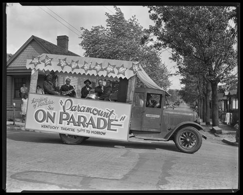 Five African-American musicians in bed of a Guthrie and Stiles truck, sign states 