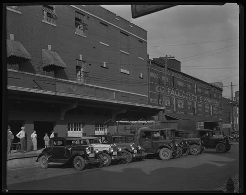 Joseph Papania & Company Wholesale Fruits and Vegetables; fleet of delivery trucks and front of company; G.Z. Faulconer & Company Cash Wholesale Grocers in background; 838 West High Street
