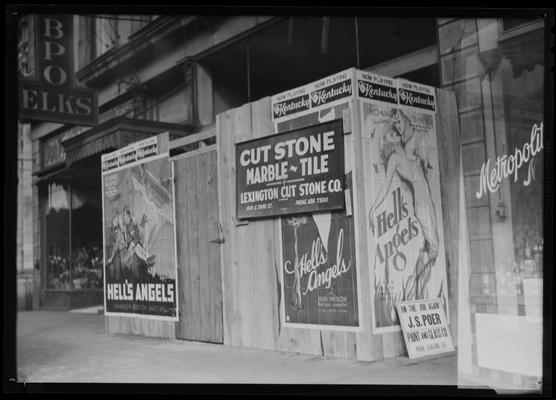 Movie poster on false front covering construction on 115 West Main; Kentucky Theatre (movie theater) advertisement for 