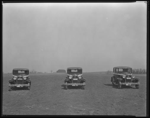 Lexington Taxi Company; cars and planes parked in field