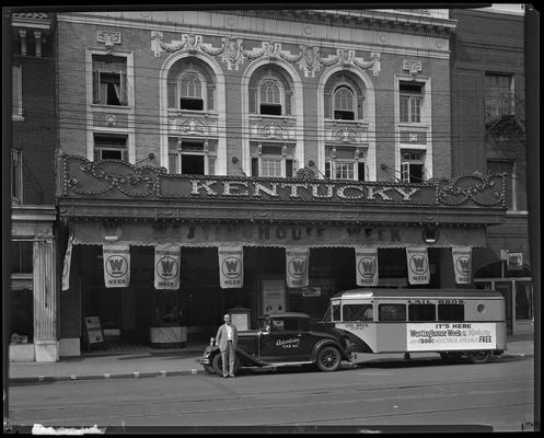 Kentucky Theatre (movie theater), 214 East Main, exterior, street scene; awning, hanging banners, and a promotional truck for 